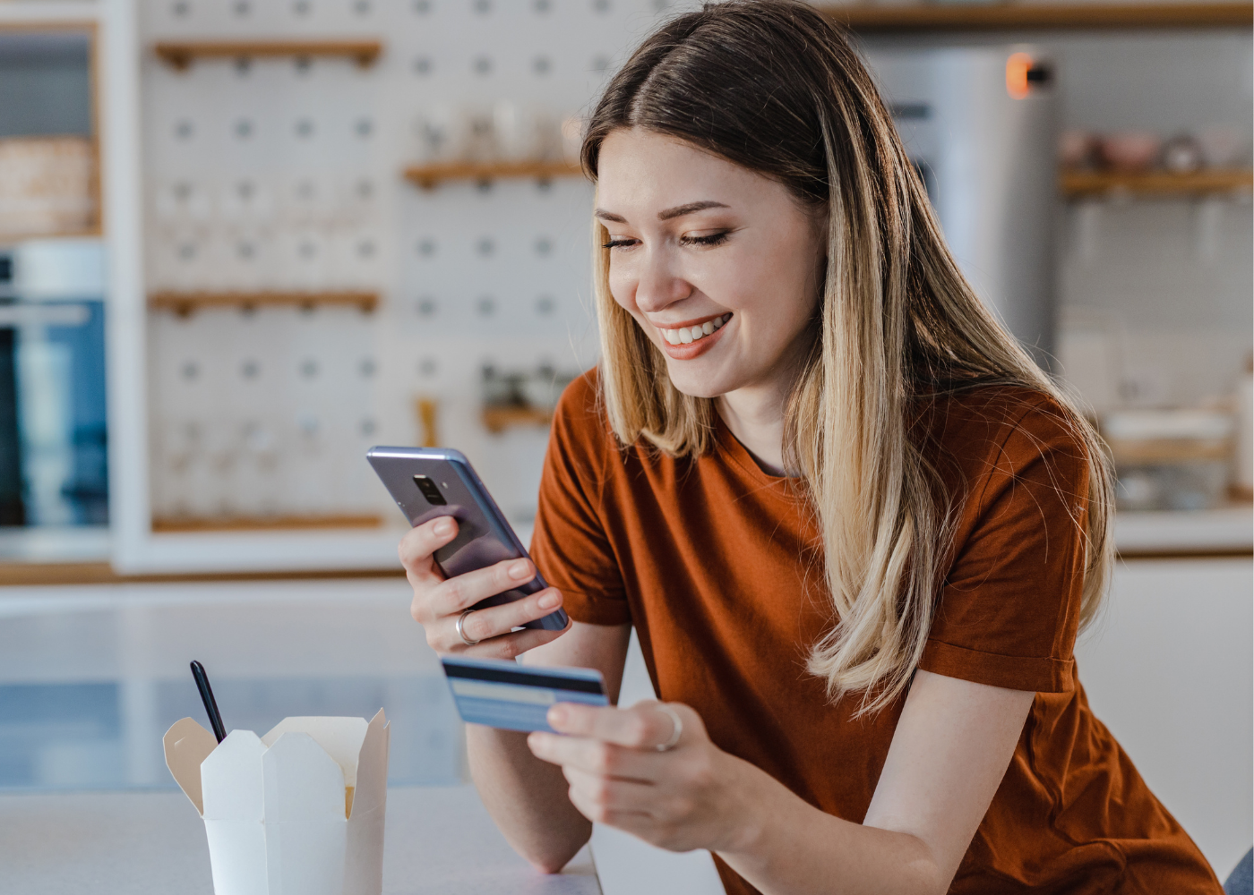Woman managing her The Police Credit Union Platinum Visa card using Card Controls in Digital Banking.