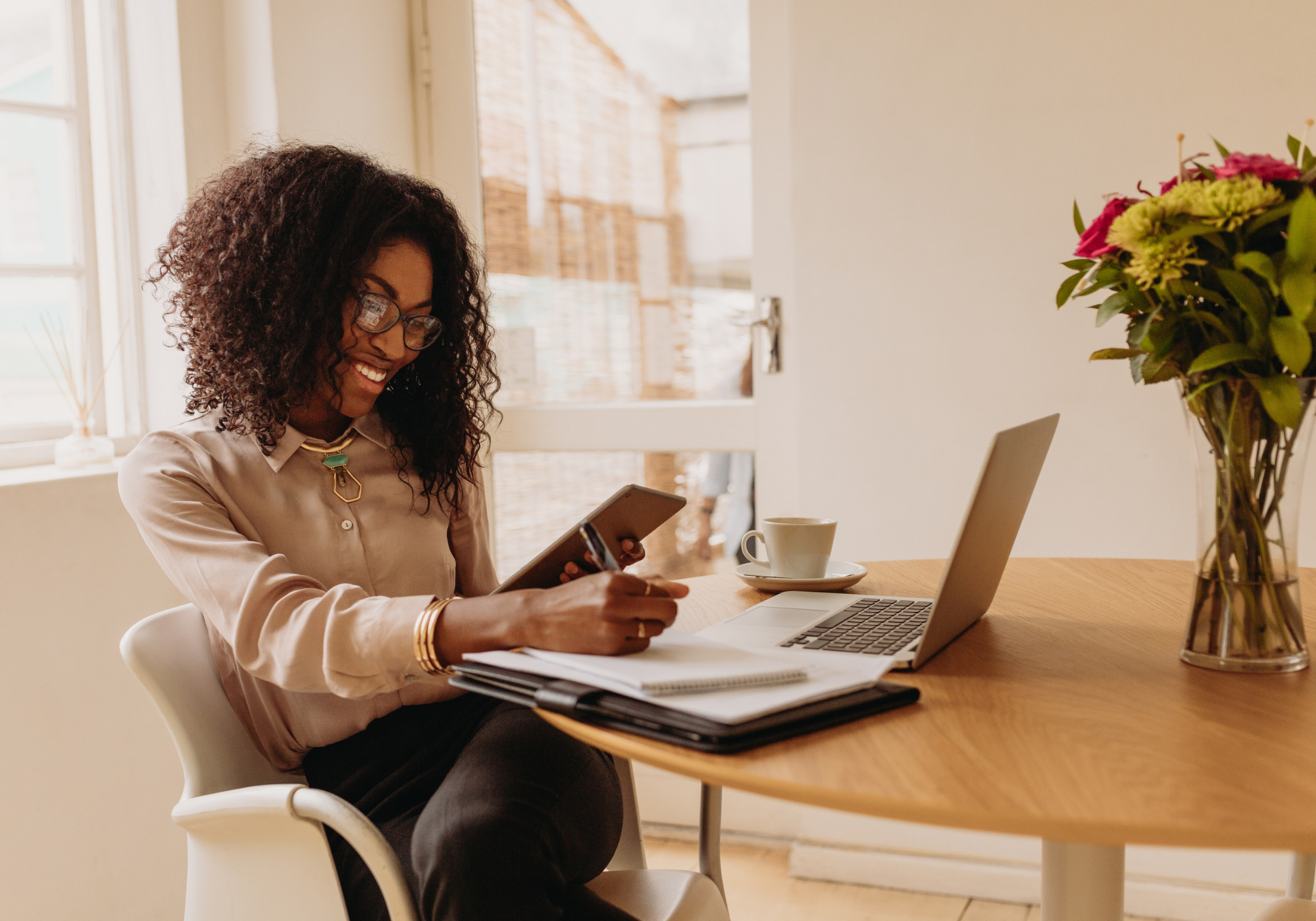 Woman reviewing mortgage documents and considering refinancing her home loan with The Police Credit Union.