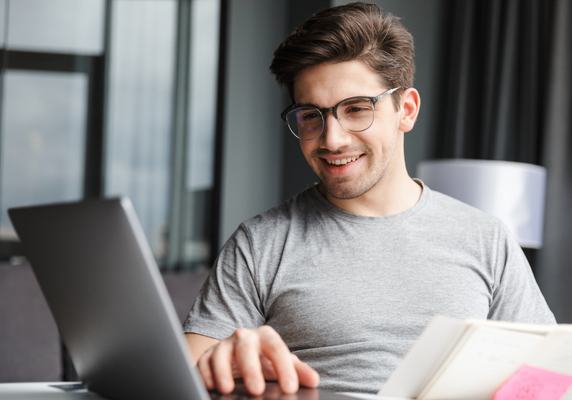 Young police officer reviewing bank accounts in Digital Banking on laptop. 